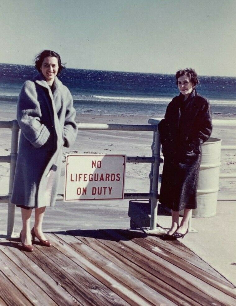 Two Women In Jackets By Lifeguard Sign At Beach Color Photograph 3.5 x 5