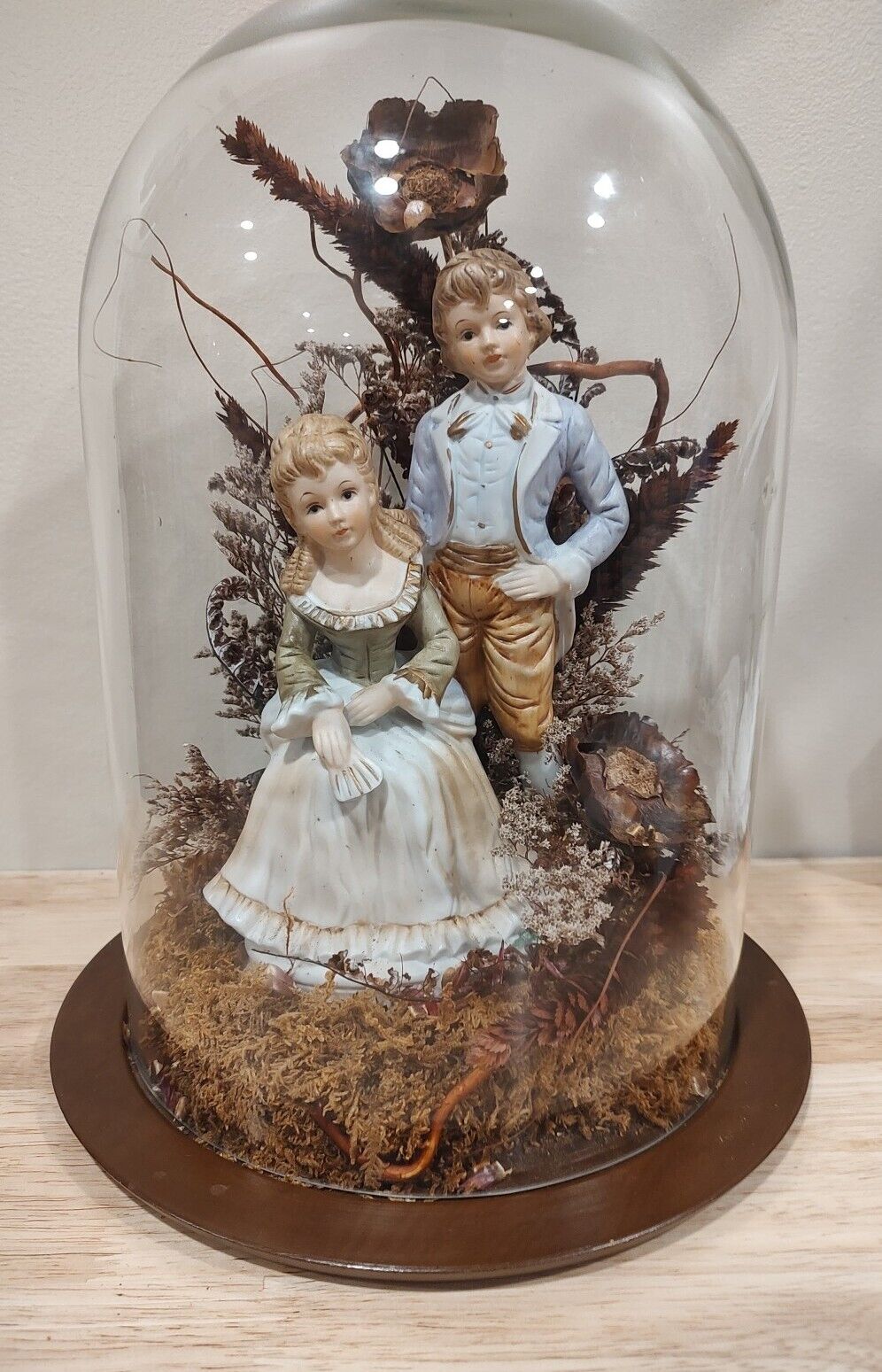 Colonial Couple Ceramic In Heavy Glass Showcase/Dried Foliage On  Wood Base*READ