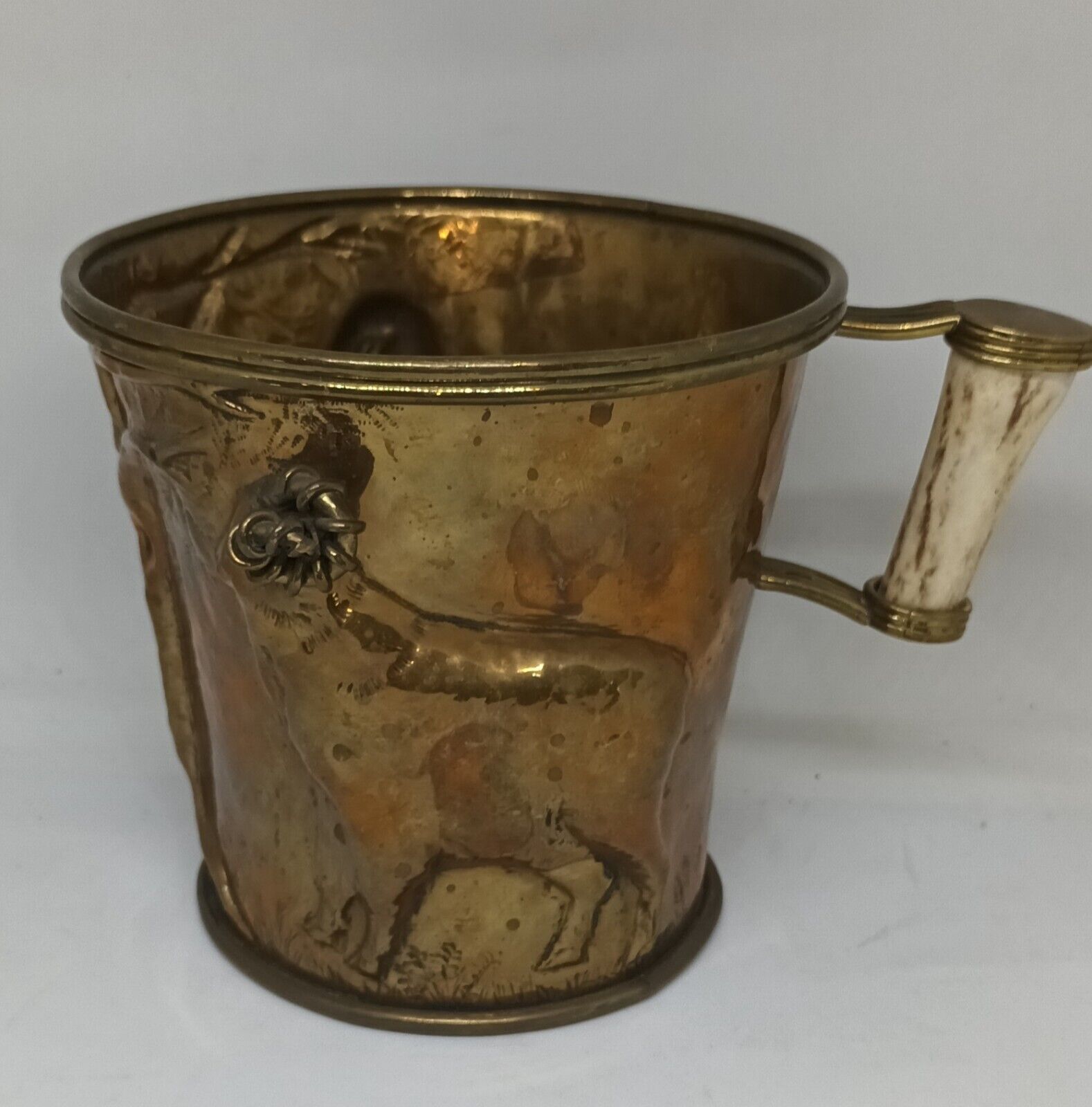 Large bronze jug worked with images of animals. Measures 14cm x 14cm
