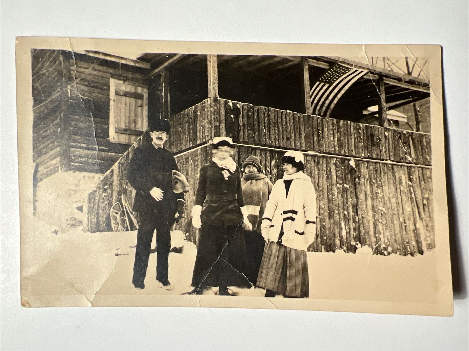antique FRIENDS in the SNOW 1900s Vintage RPPC Photo AMERICAN FLAG Log Cabin