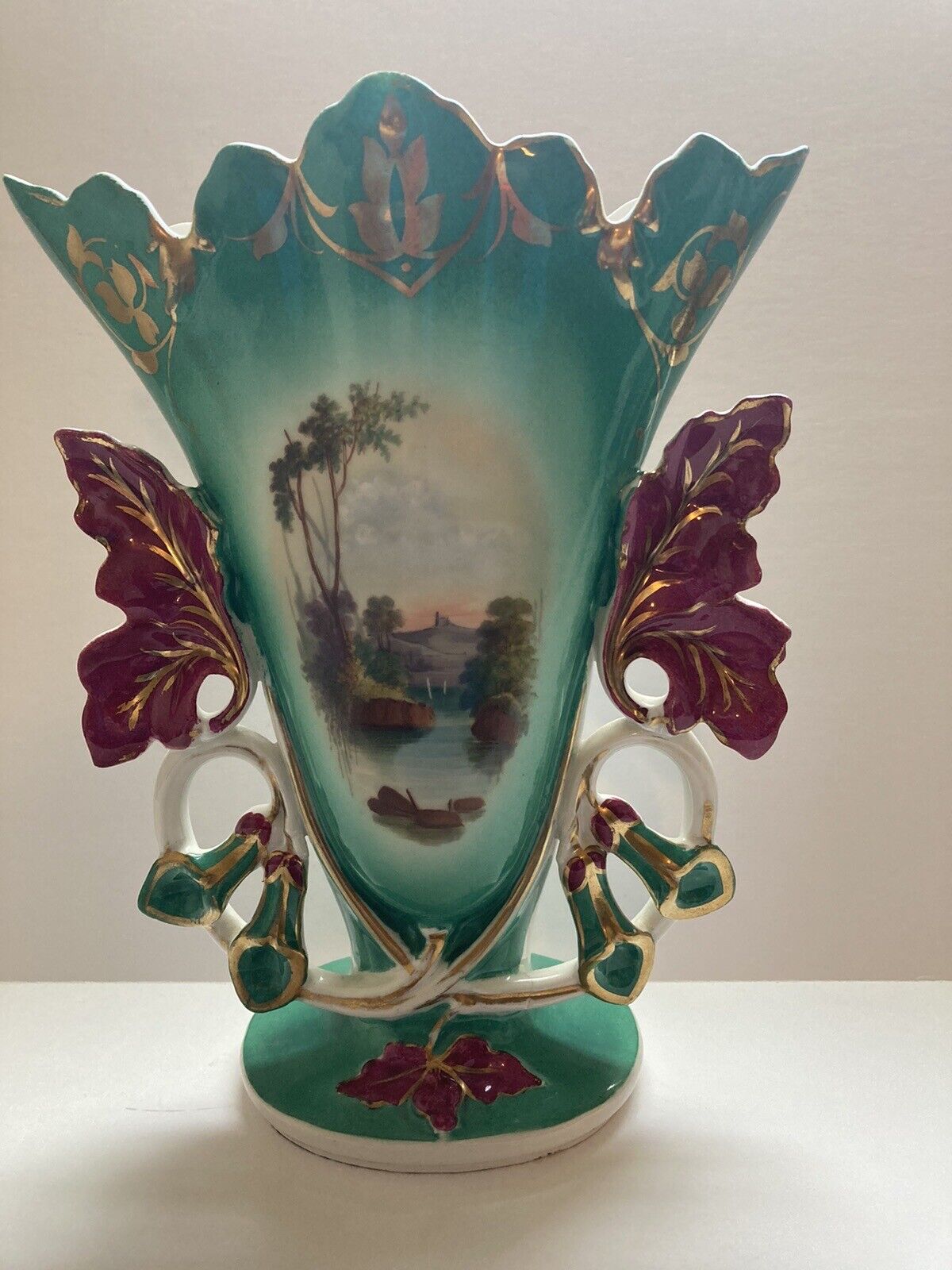 In the style of Old Paris Porcelain 11.5 inch handled vase. No maker marks.