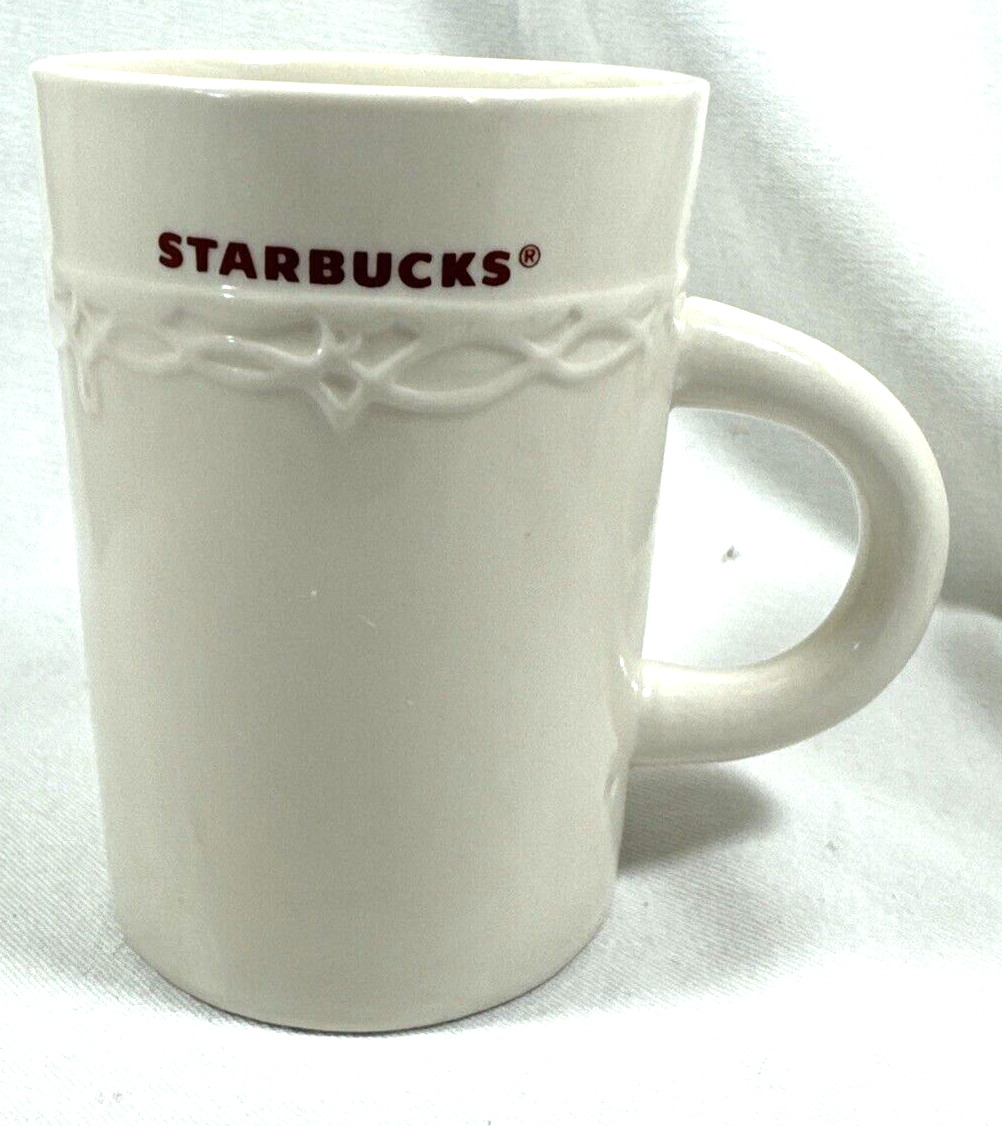 2010 STARBUCKS HOLIDAY COFFEE CUP MUG EMBOSSED IVORY DESIGN 10 OZ