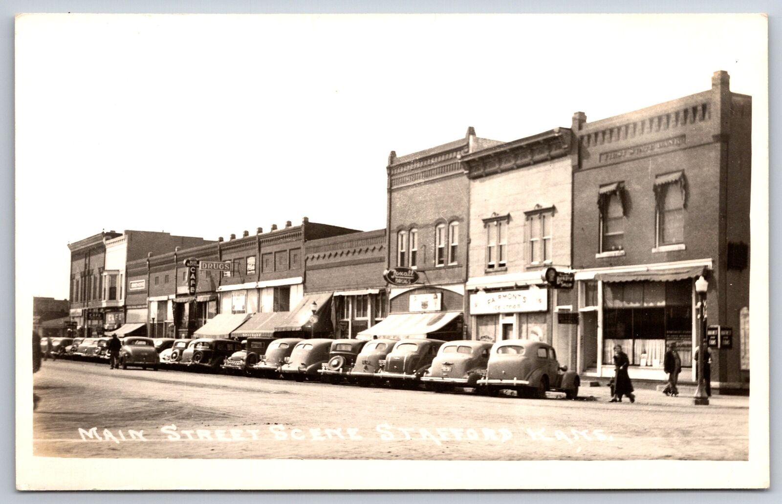 Stafford Kansas~Main St~Blue Bottom Cafe~Fairmont\'s Ice Cream~Rexall~1930s RPPC