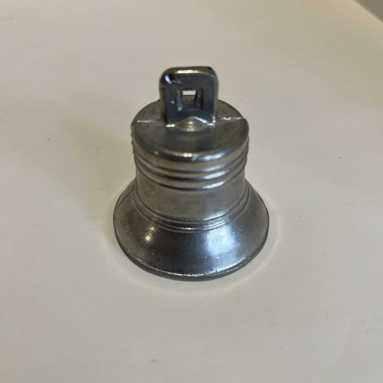 Vintage small metal bell.  1.75 inches tall.  1.75 inches diameter. Silver Tone