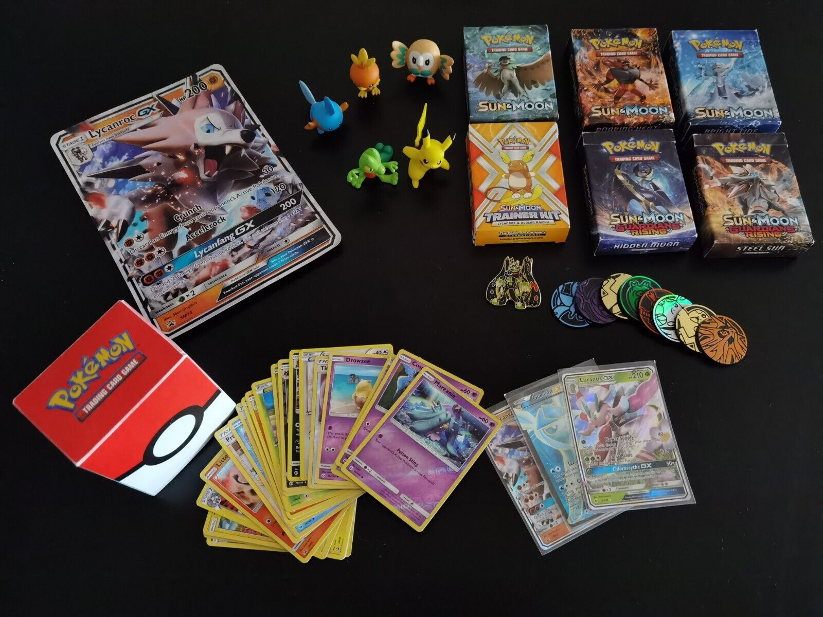 Pokemon card game collection with coins, pin and miniatures.
