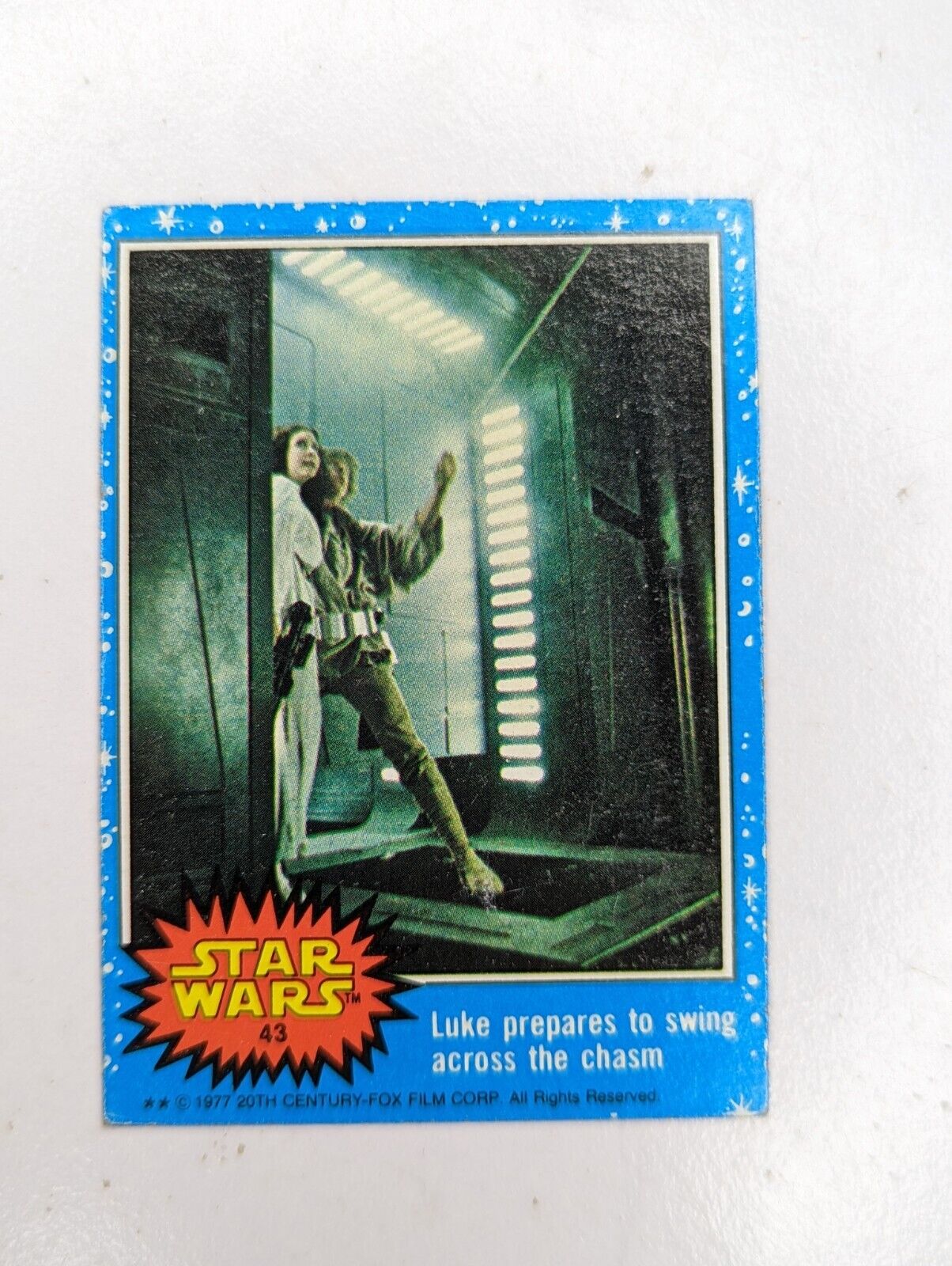 1977 Topps Star Wars Blue Series 1 #43 Luke prepares to swing across the charm