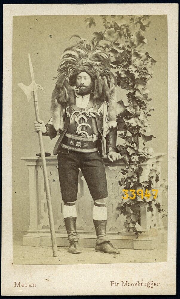 man in amazing strange costume, pipe, halbert, tusks, antique CDV, 1870's MERAN