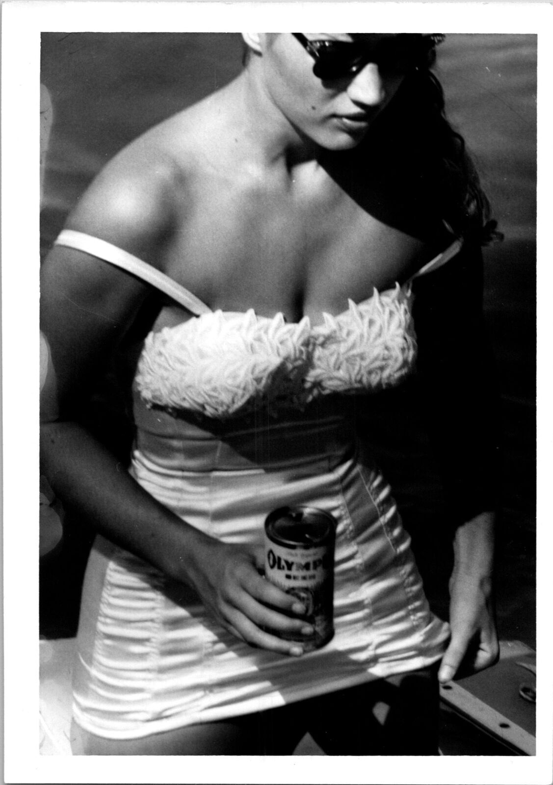 Pretty woman wearing white bathing suit hold Olympia beer can Found Photo V0467