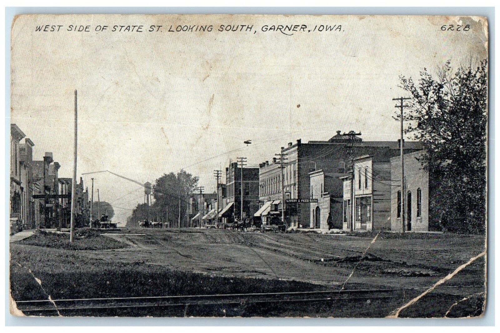 1914 West Side Of State St. Looking South Livery & Feeb Barn Garner IA Postcard