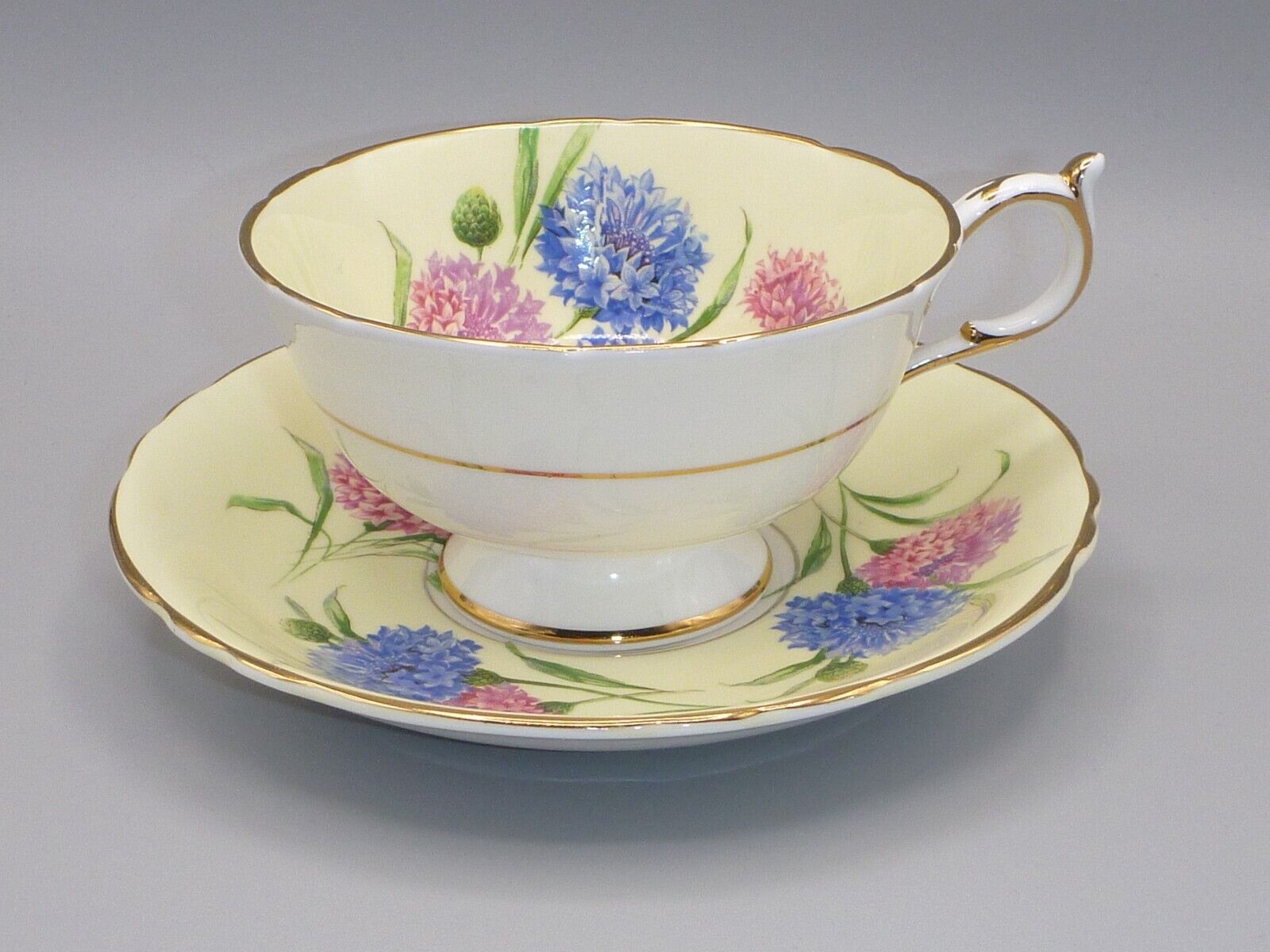 PARAGON DOUBLE WARRANT TEACUP & SAUCER SET, YELLOW WITH PINK & BLUE CORNFLOWERS