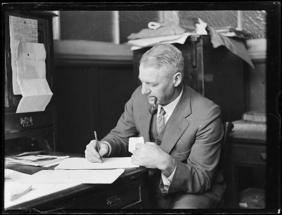 Mr Theodore smoking a pipe and writing on his desk NSW 1930 Old Photo