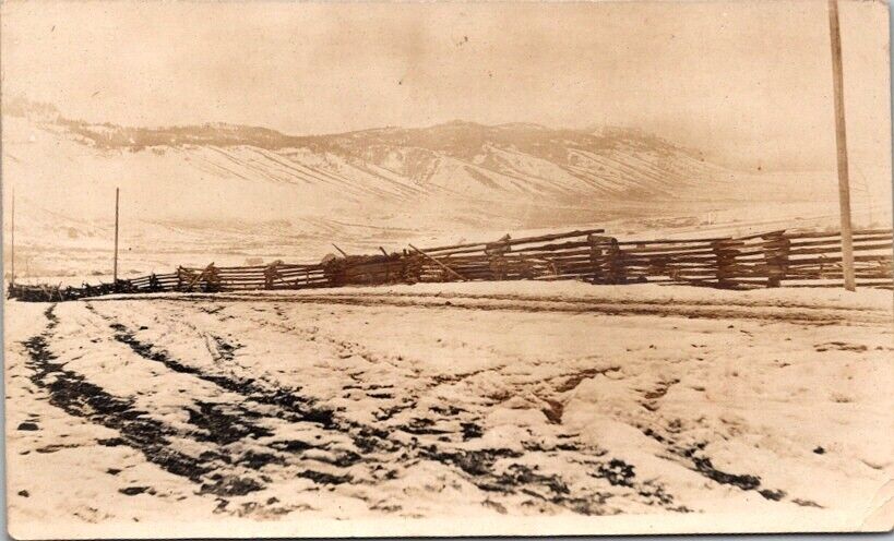 RPPC Postcard Snowy View  Split Rail Fence along Road and Mountain Plateau 12573