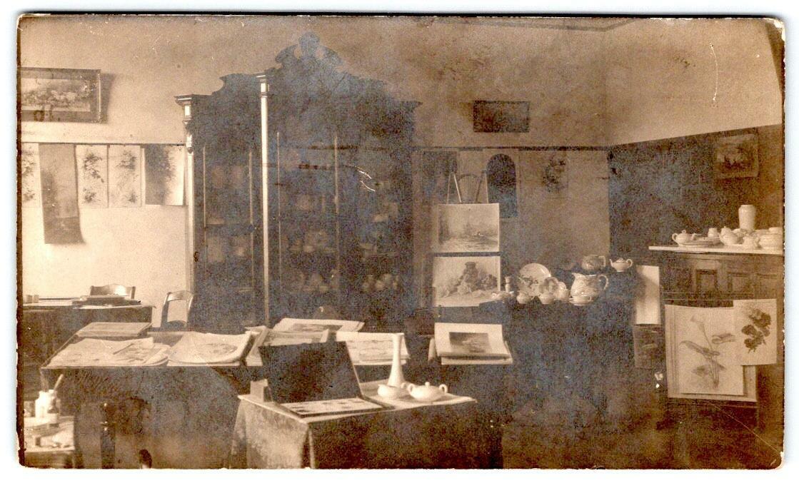 1911 RPPC CHICAGO ART STUDIO ROOM INTERIOR*PAINTINGS*MARIE IS HOMESICK*TRIMMED