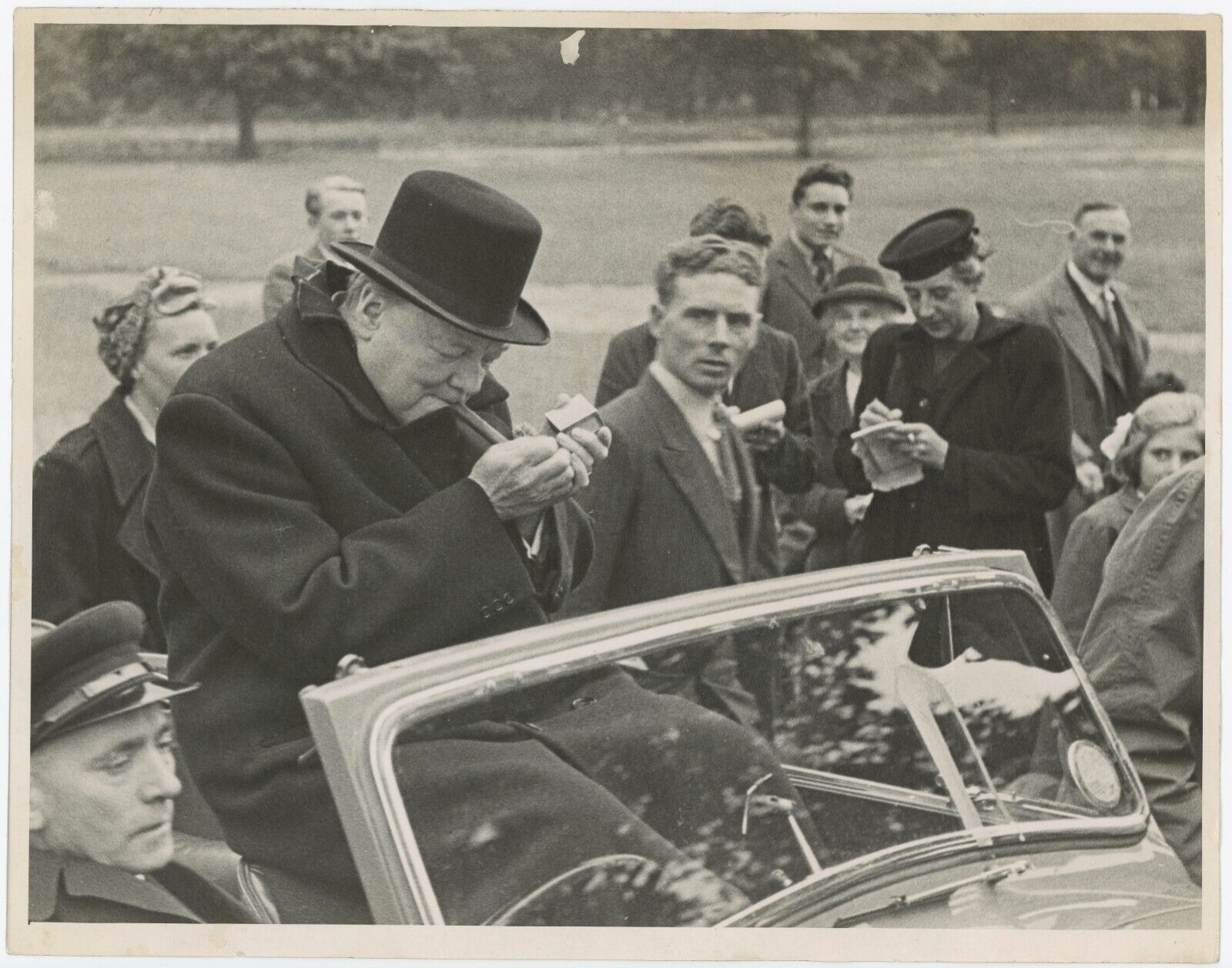 July 1945 press photo of Winston Churchill lighting a cigar on the hustings