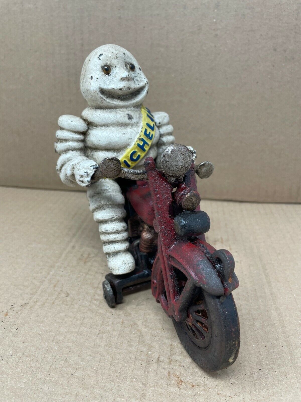 Cast Iron Michelin Man Tire Guy Figure on a Motorcycle