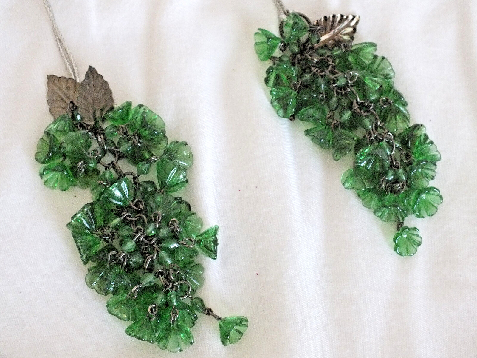 Approximately 80 tiny green glass flowers hanging like wisteria w/4 metal leaves