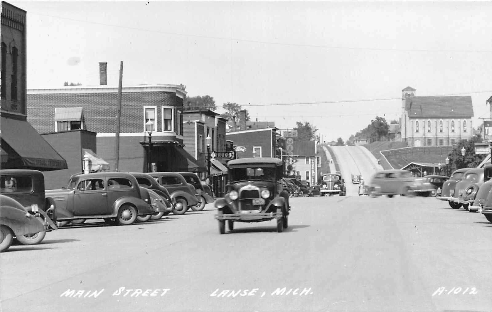 G92/ Lanse Michigan RPPC Postcard c1930s Main Street Autos Stores