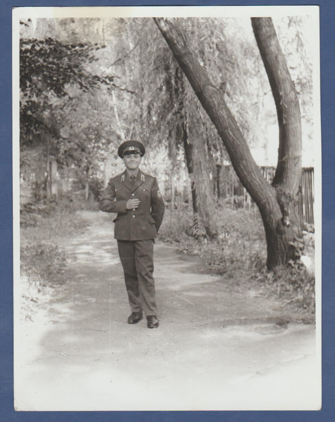Beautiful boy soldier near a tree. Soviet soldier. Soviet Vintage Photo USSR