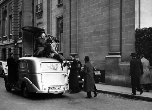 Sitting on roof a car, photographers & cameramen follow two men do- Old Photo