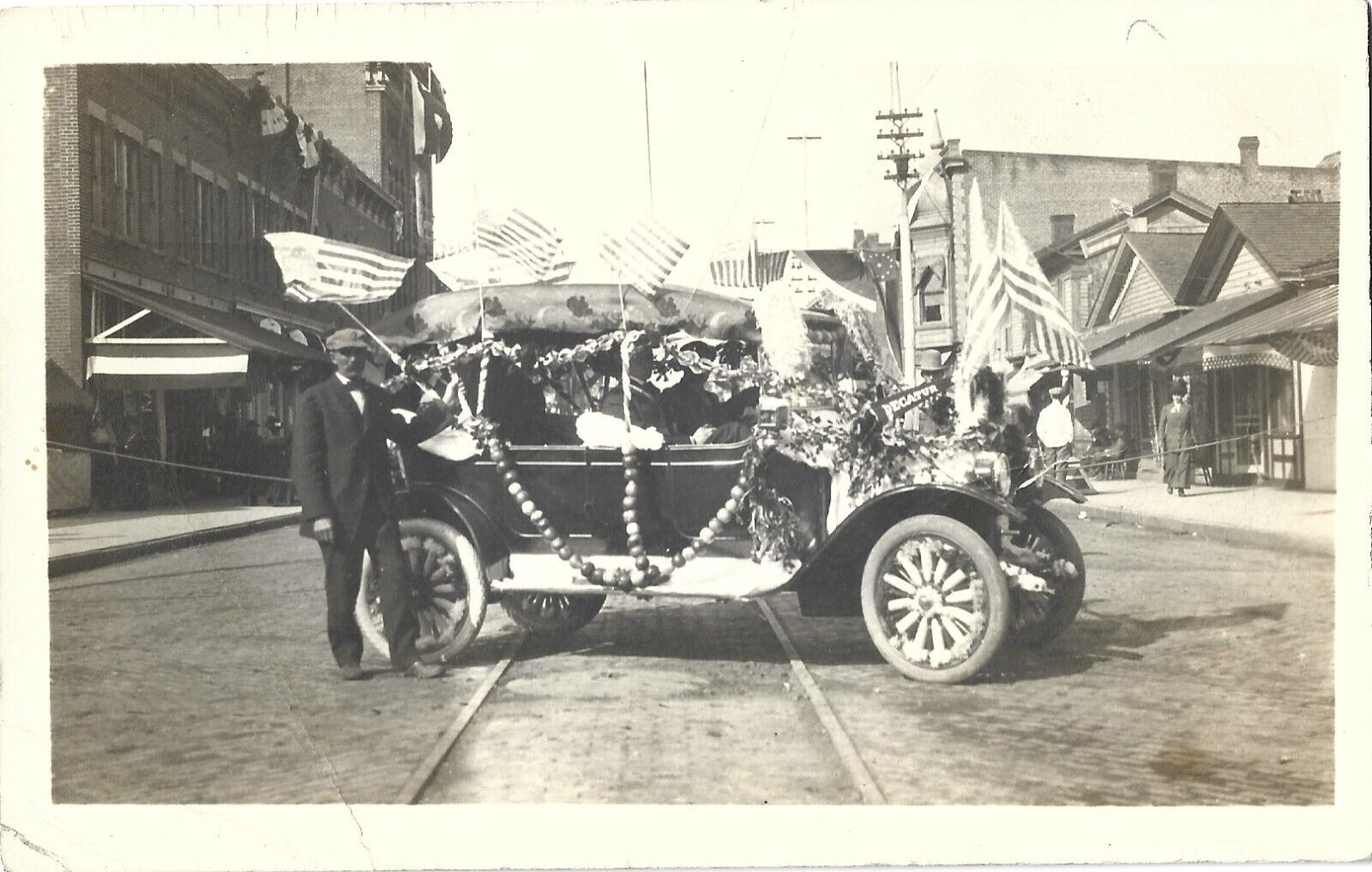 Decatur MI -- Model T with flags/decorations in parade; nice 1910s RPPC