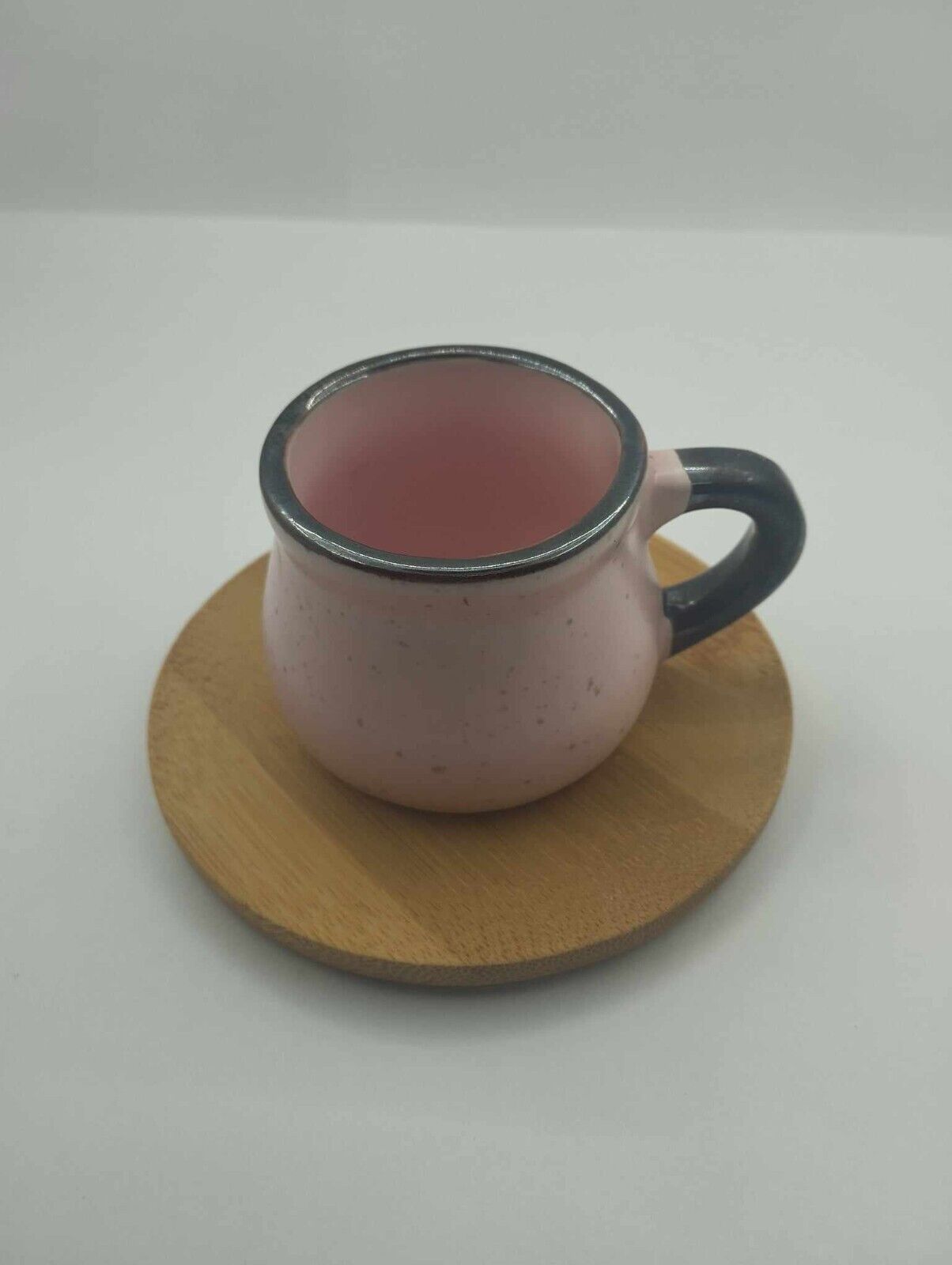 Ceramic coffee cup with wooden cup saucer
