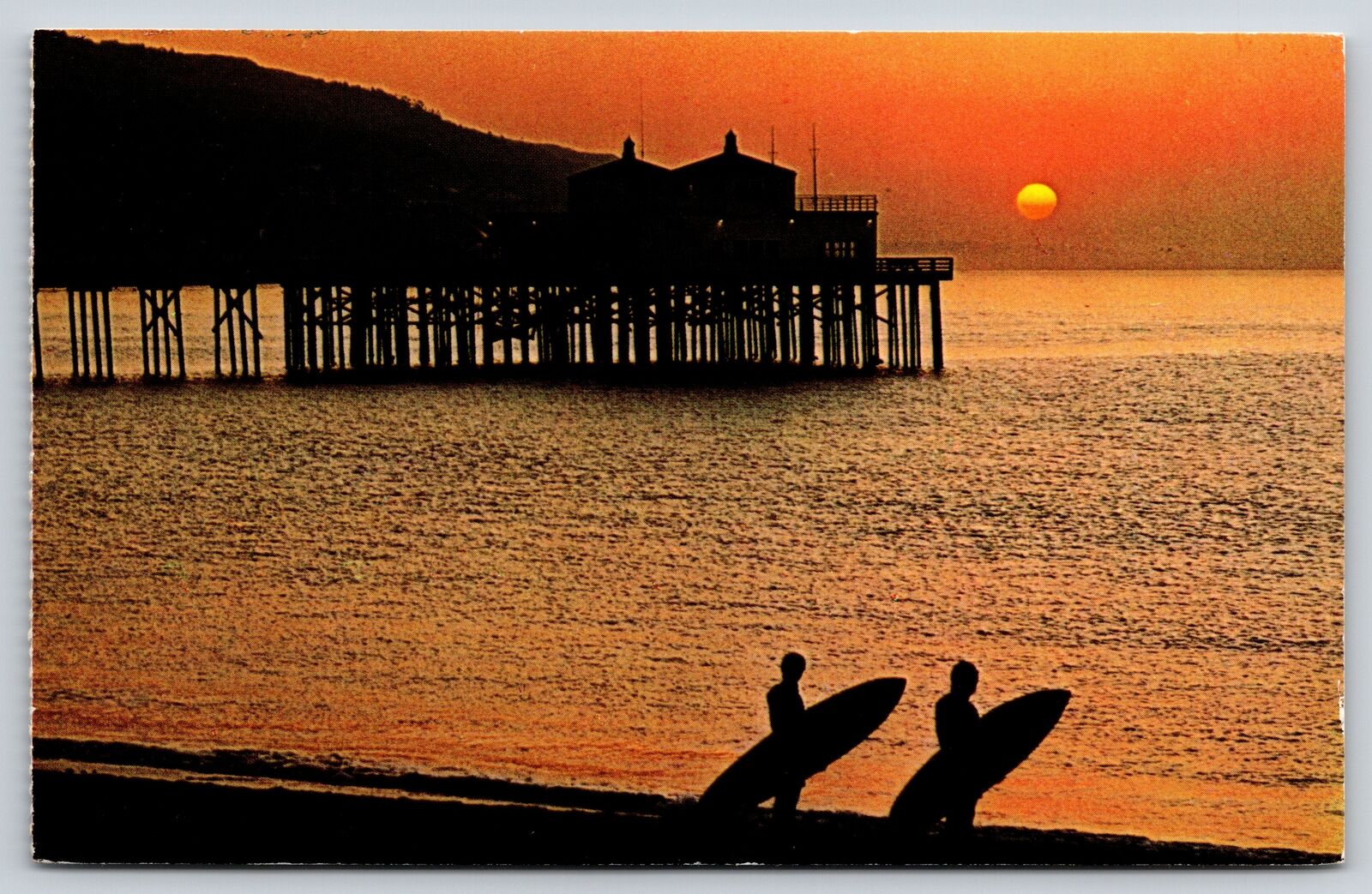 Malibu California~Silhouette~Surfers On Beach @ Sunset by Pier~Vintage Postcard