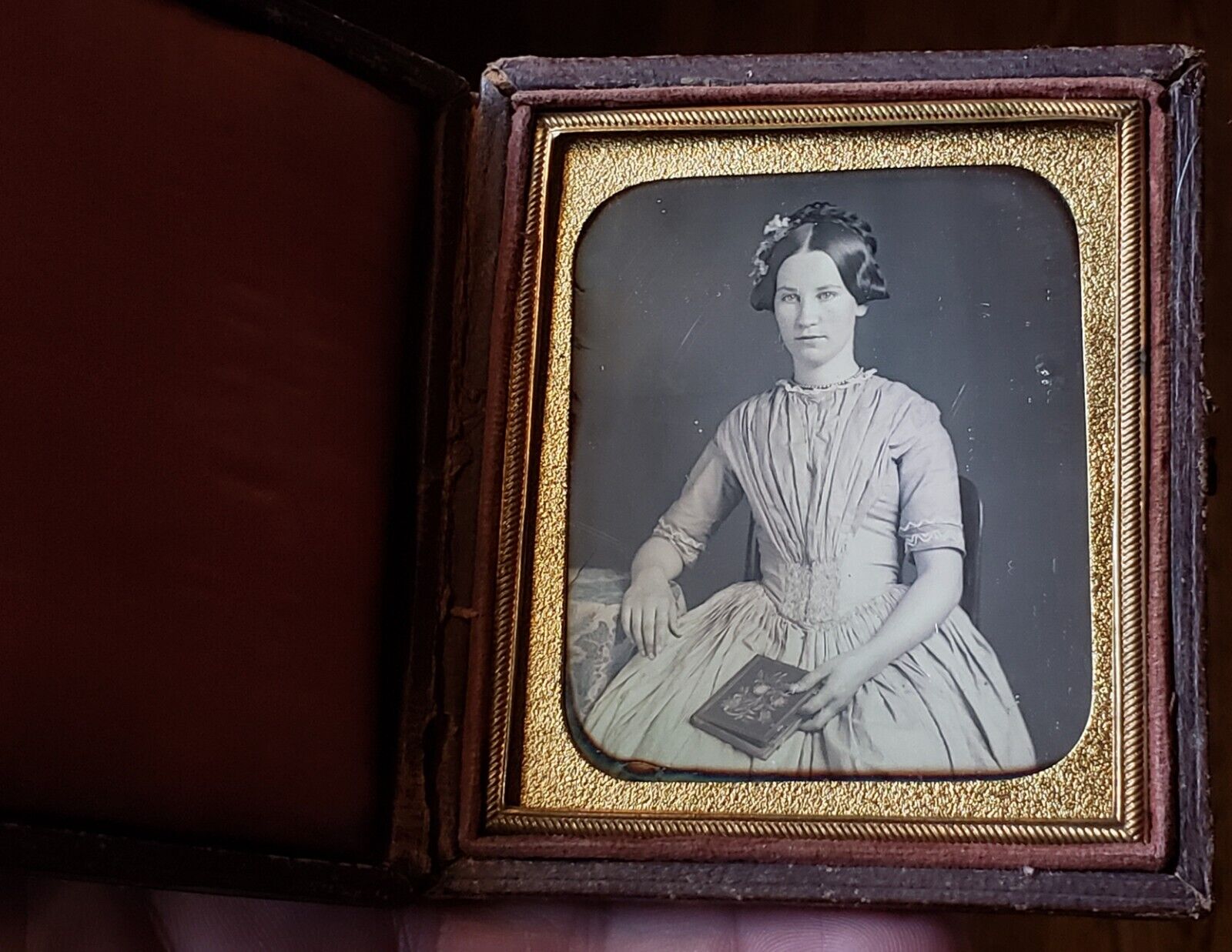 sixth plate daguerreotype of beautiful young woman holding a book early case