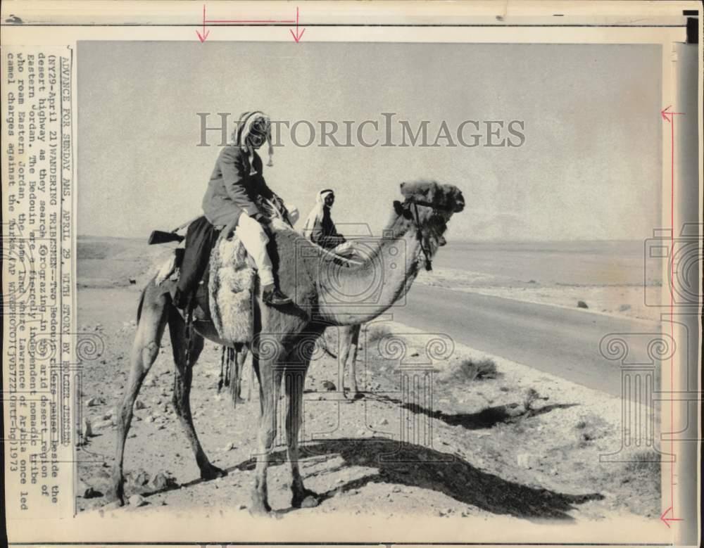 1973 Press Photo Bedouin camel riders pause on desert highway in Jordan