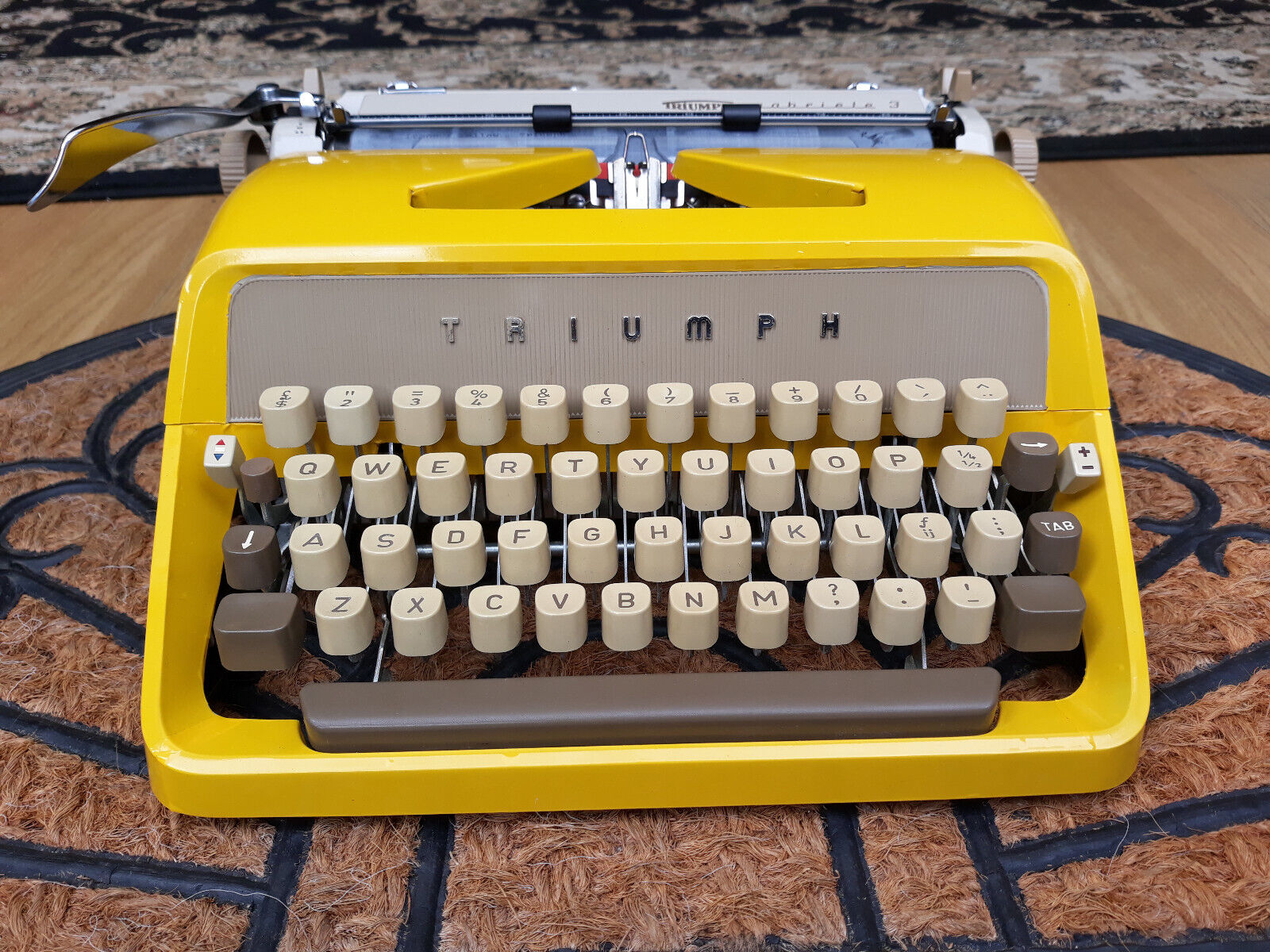 vintage mustard yellow Triumph portable typewriter working with case