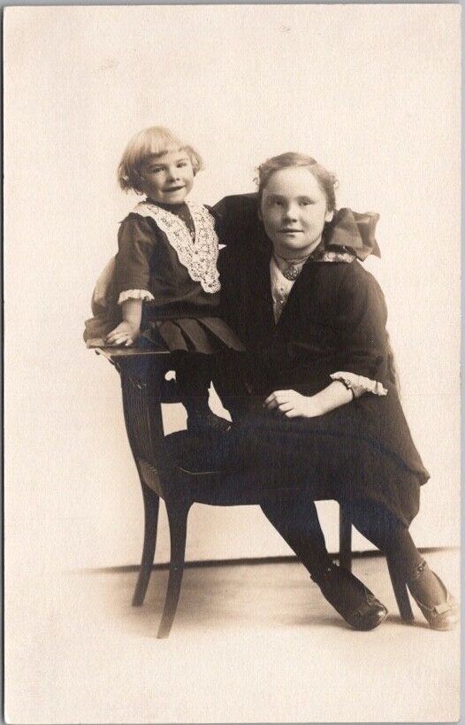 1910s Studio RPPC Postcard Girl with Sister that Looks Like Ventriloquist\'s Doll