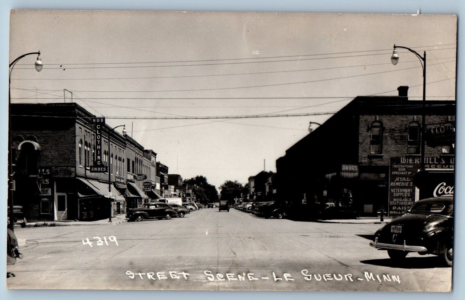 Le Sueur Minnesota MN Postcard RPPC Photo Street Scene Hub Clothing Shoes c1940s