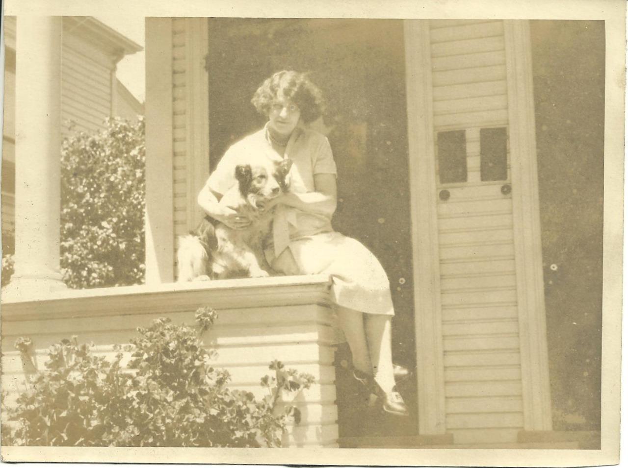 Vintage sepia photo dog & girl lovely young lady & sweet pup on porch