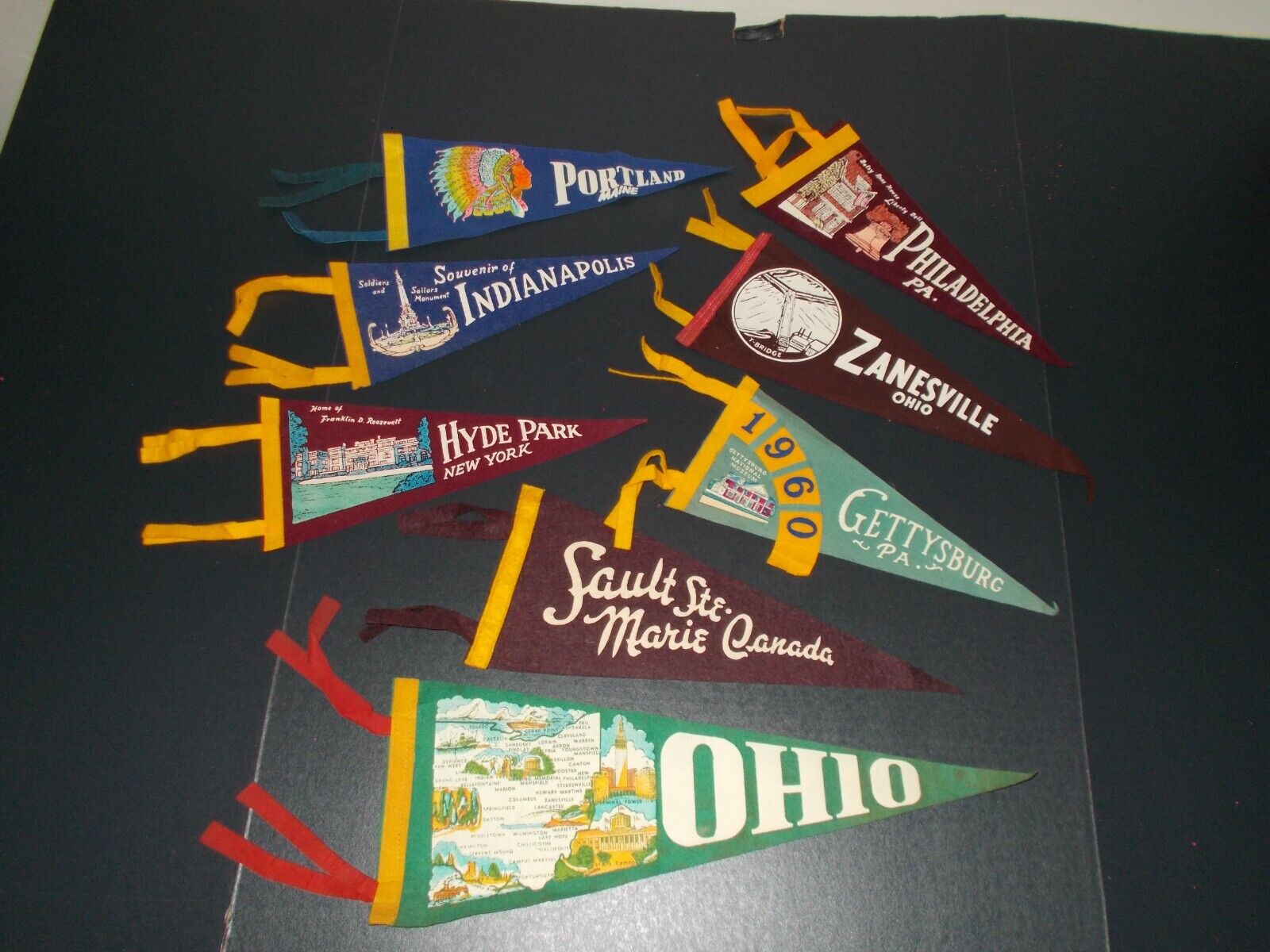 VTG LOT OF 8 DIFFERENT SMALL PENNANTS.