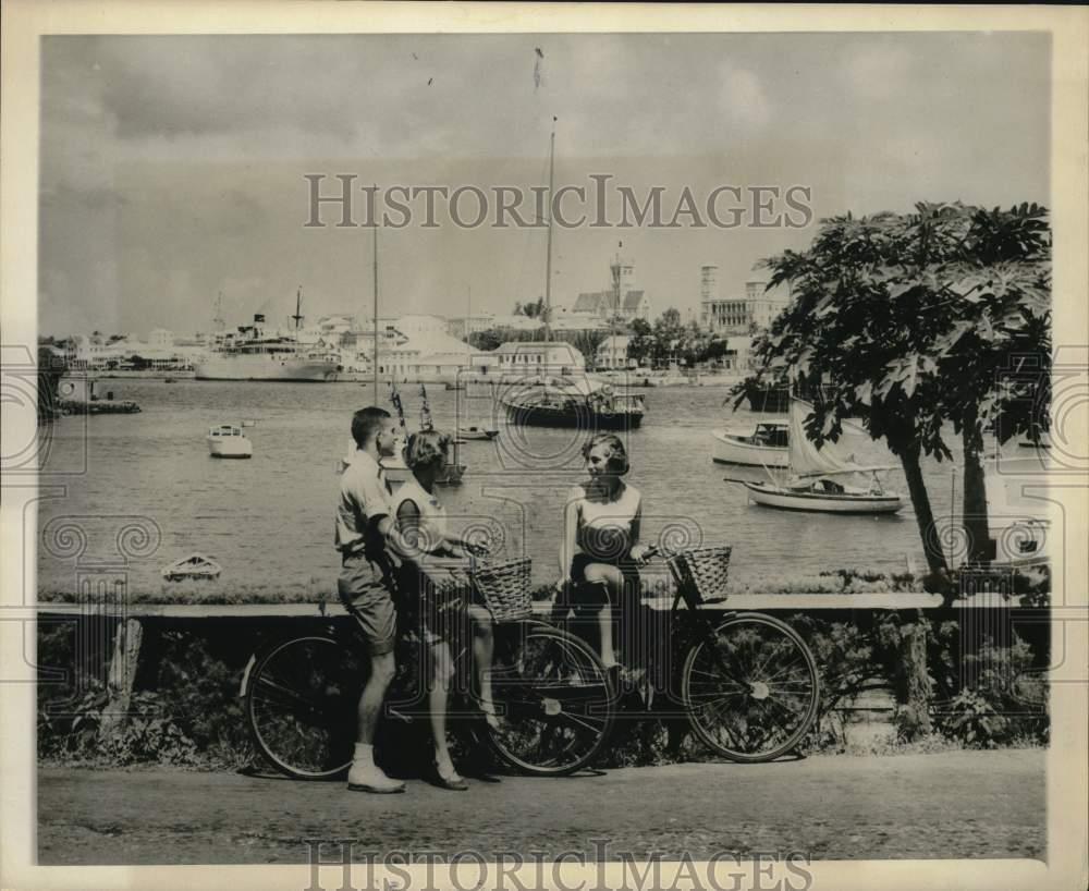 1953 Press Photo Tourists bicycling in Hamilton, Bermuda - saa65784