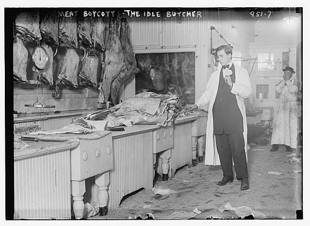 Butcher stands idle before his counter of meat during the meat boycott,1910