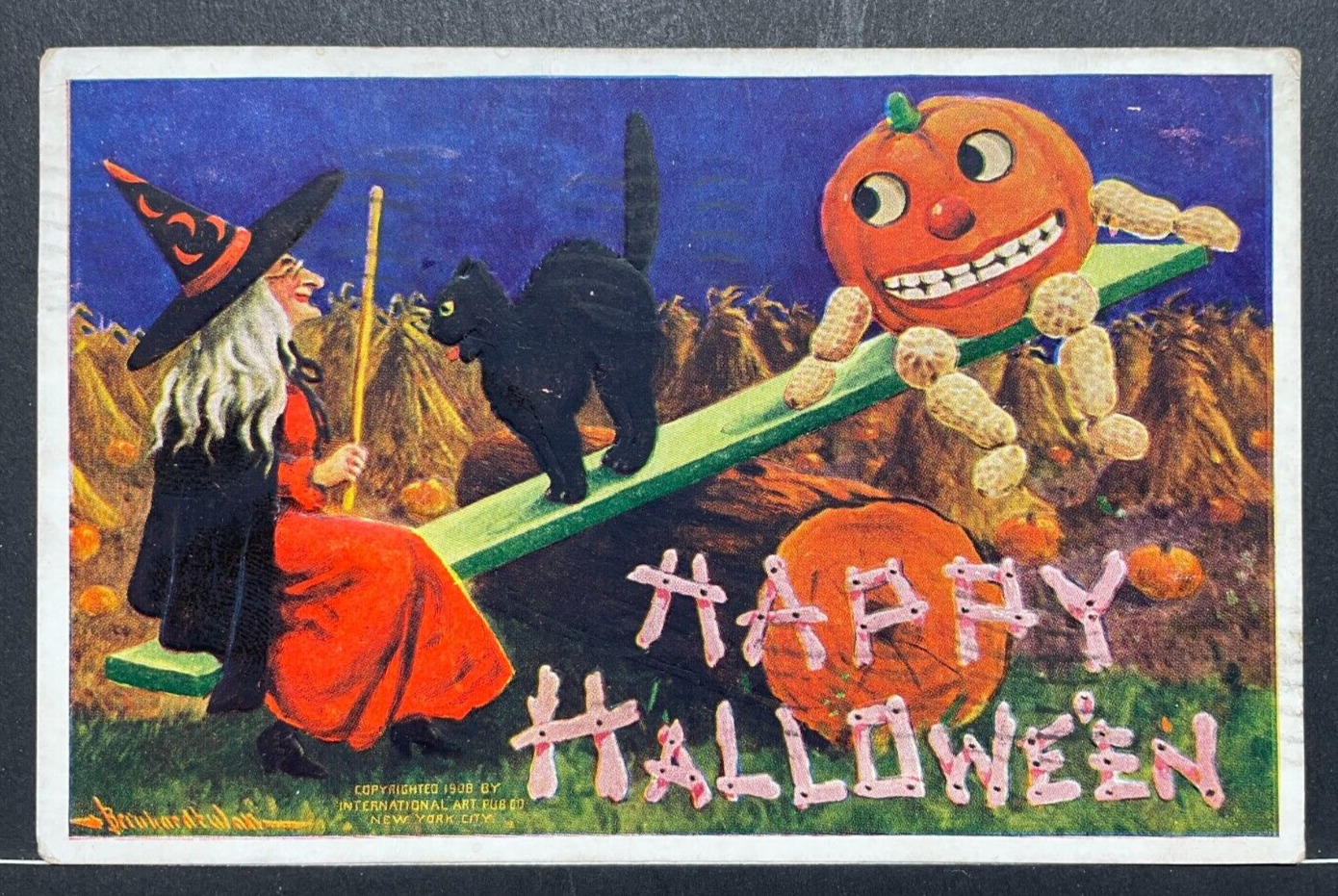Halloween Postcard International Art Publishing  Witch Cat J-O-L on see-saw 1909