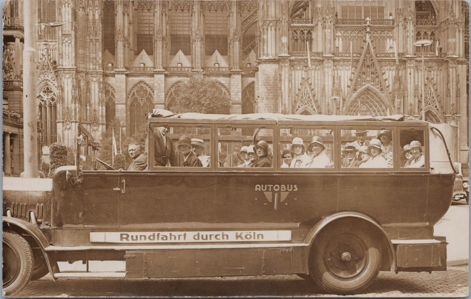 RPPC c1920\'s Cologne Germany Tour Bus at Catholic Gothic Cathedral Tourist Faces