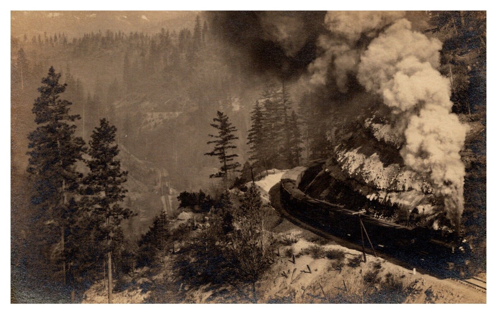 postcard Train billows smoke around curve RPPC c1910-1924 A1070