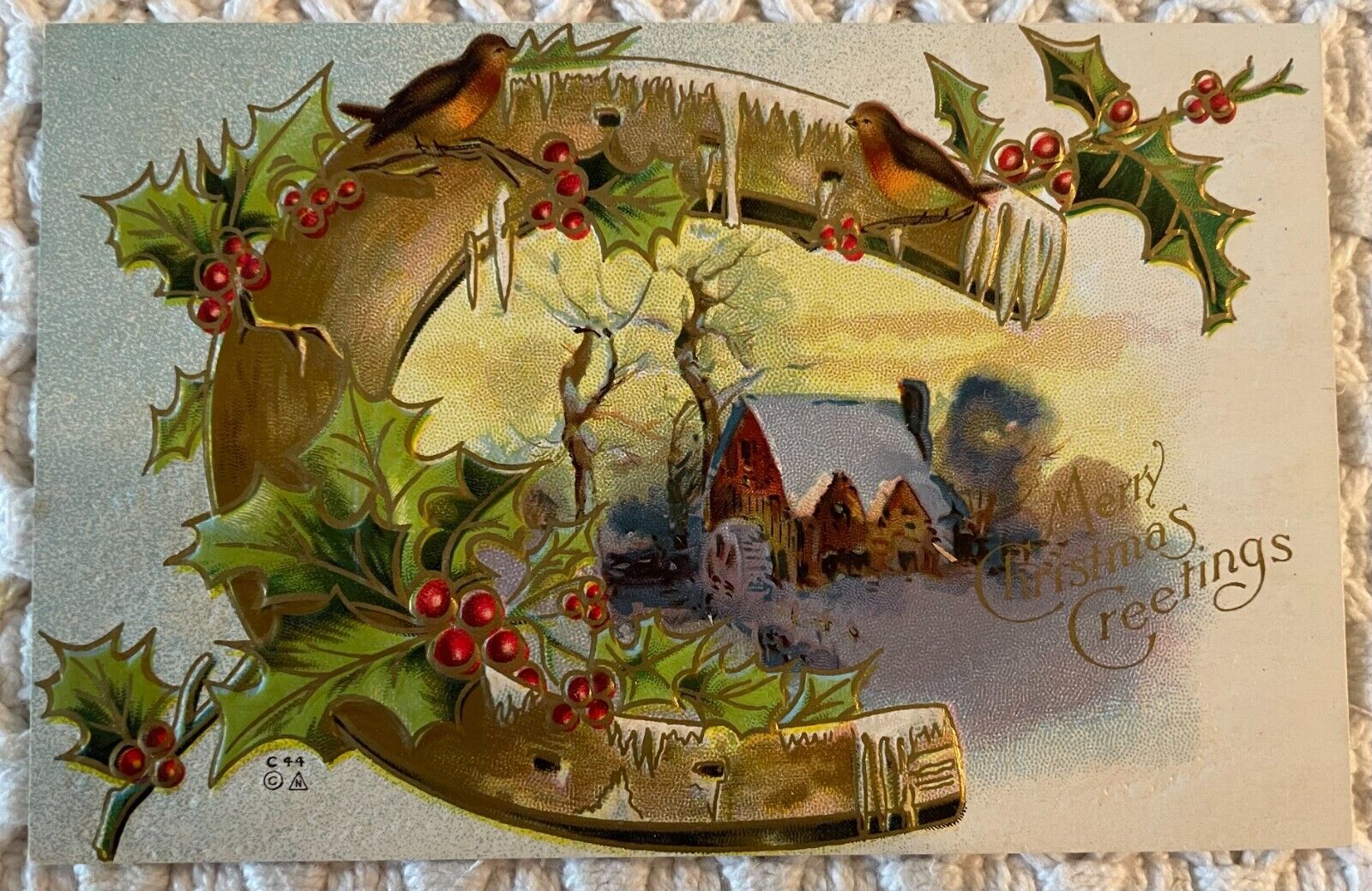 Merry Christmas Greetings postcard Cottage Scene inside horseshoe embossed
