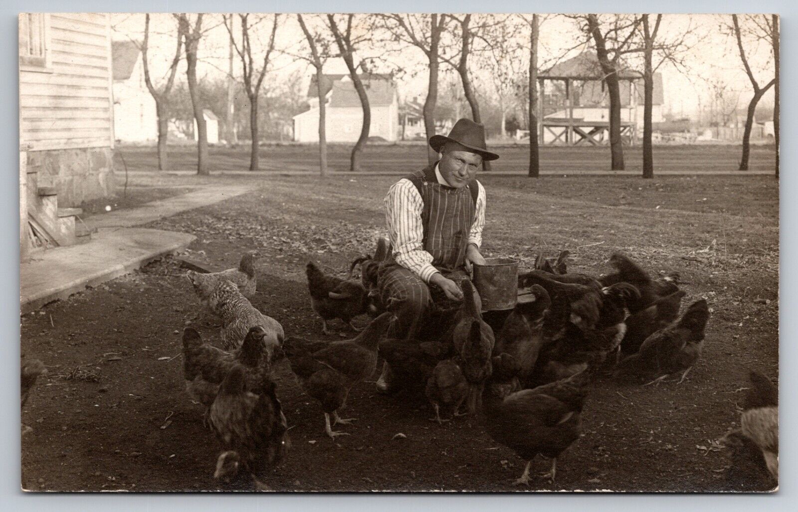 Man Feeding Chickens South Dakota SD c1910 Real Photo RPPC