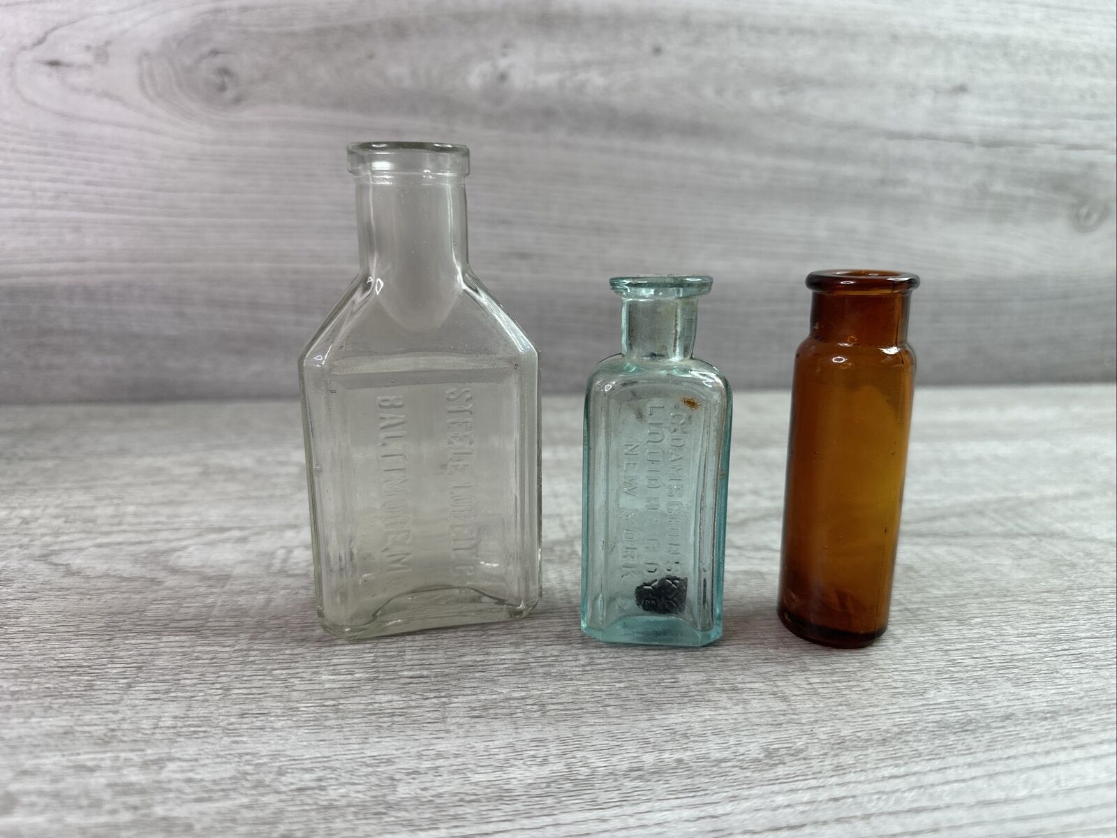 Lot Of 3 Vintage Quack Medicine Bottles Embossed Aqua, Amber & Clear