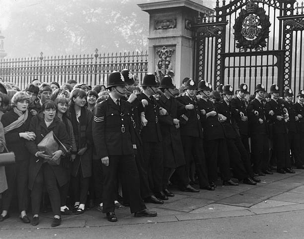 Policemen holding back crowds of young fans of pop group The - 1965 Old Photo 1