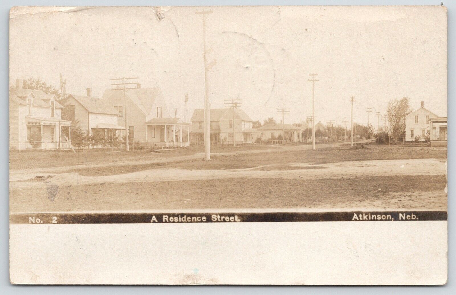Atkinson Nebraska~Line of Larger Homes Along Dirt Main Street~1908 RPPC Postcard