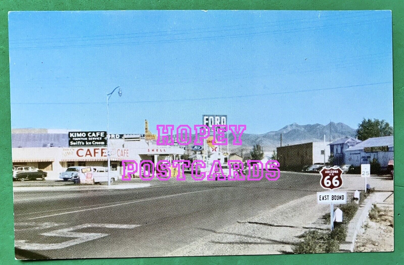 ROUTE 66 ~ KINGMAN, AZ ~ EAST BOUND 66 SIGN ~ KIMO CAFE ~ CARS ~ postcard~ 1950s