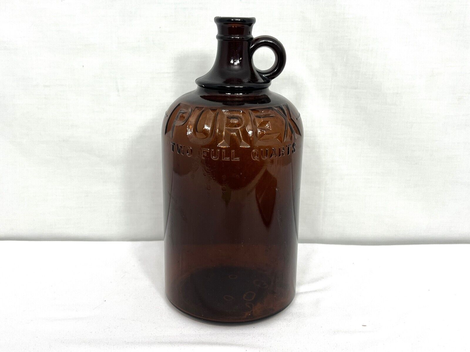 Vintage 1930s Purex 2 quart brown glass jug with finger loop, cork plug stopper