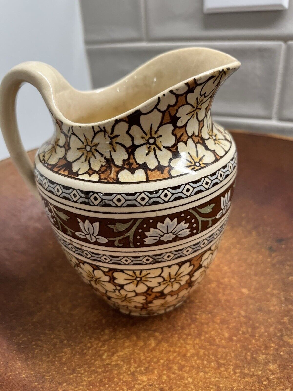 Vintage Brown And Blue Floral Ceramic Pitcher. Stained And Crazed