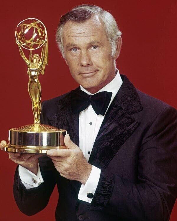 Johnny Carson in tuxedo holding Emmy Award statue 16x20 inch poster