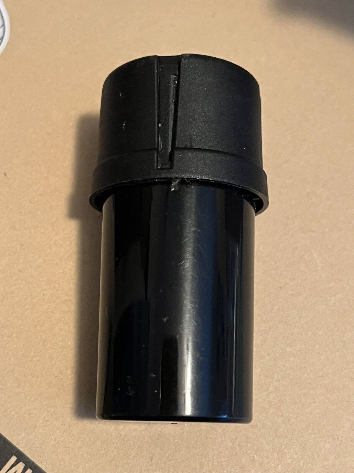 Tobacco stash storage container jar with built-in grinder. Black.