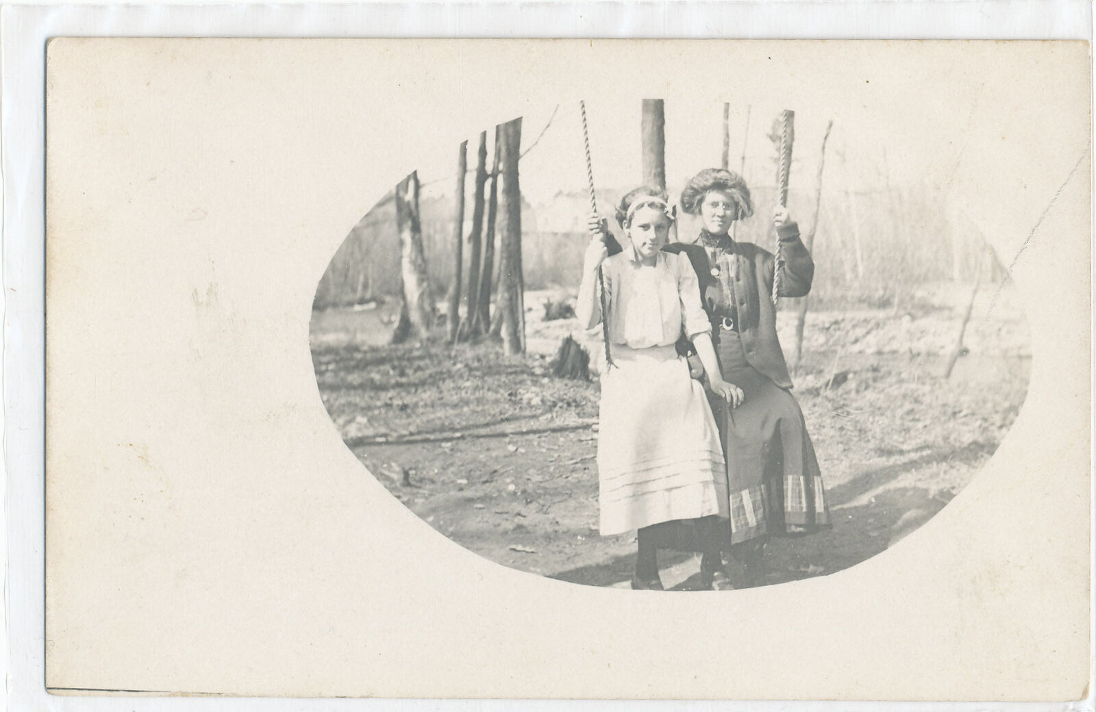 RPPC Two Women on a Swing -wooded area trees - B&W PHOTO postcard No
