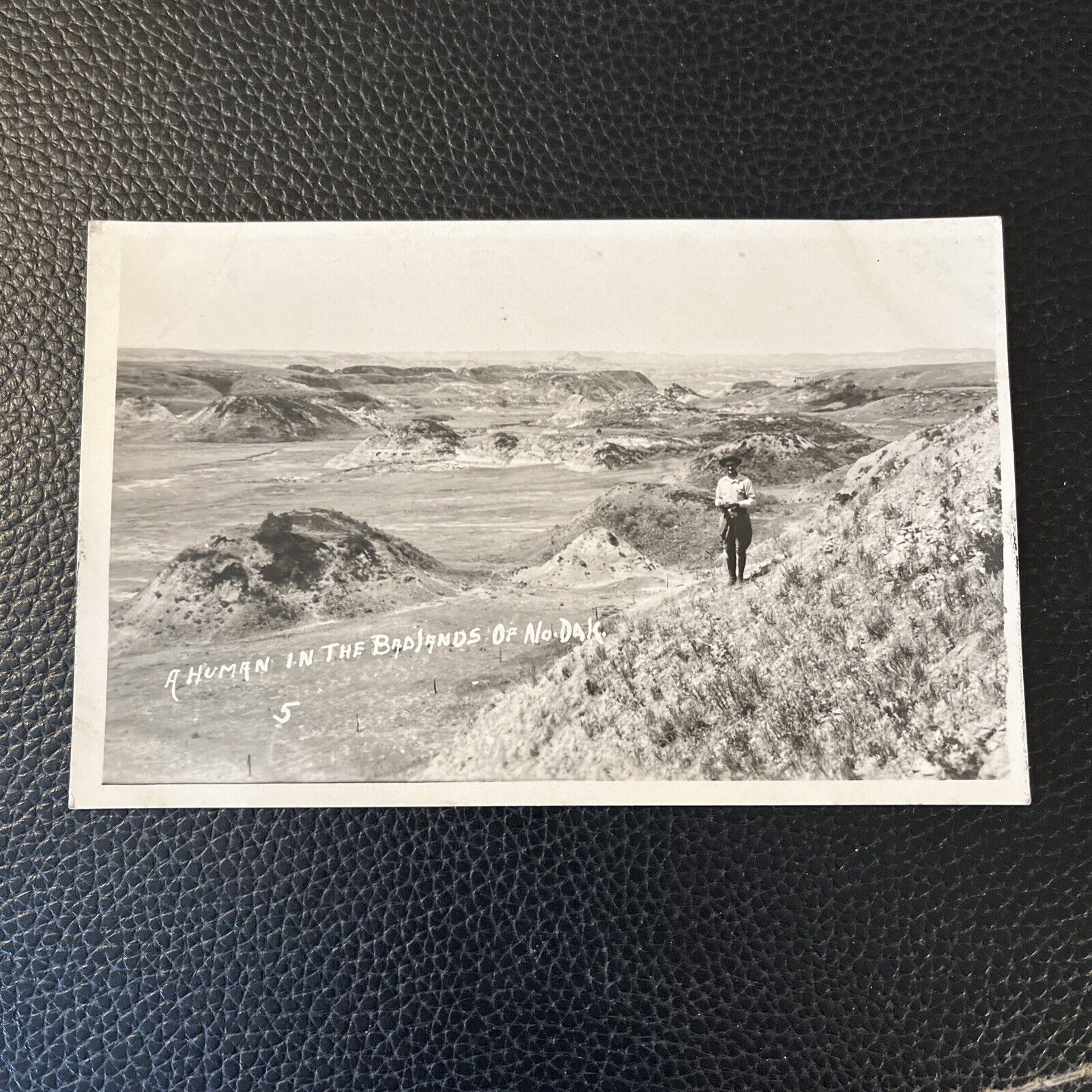 RPPC Postcard--NORTH DAKOTA--A Human in the Badlands--Man Posing Landscape View